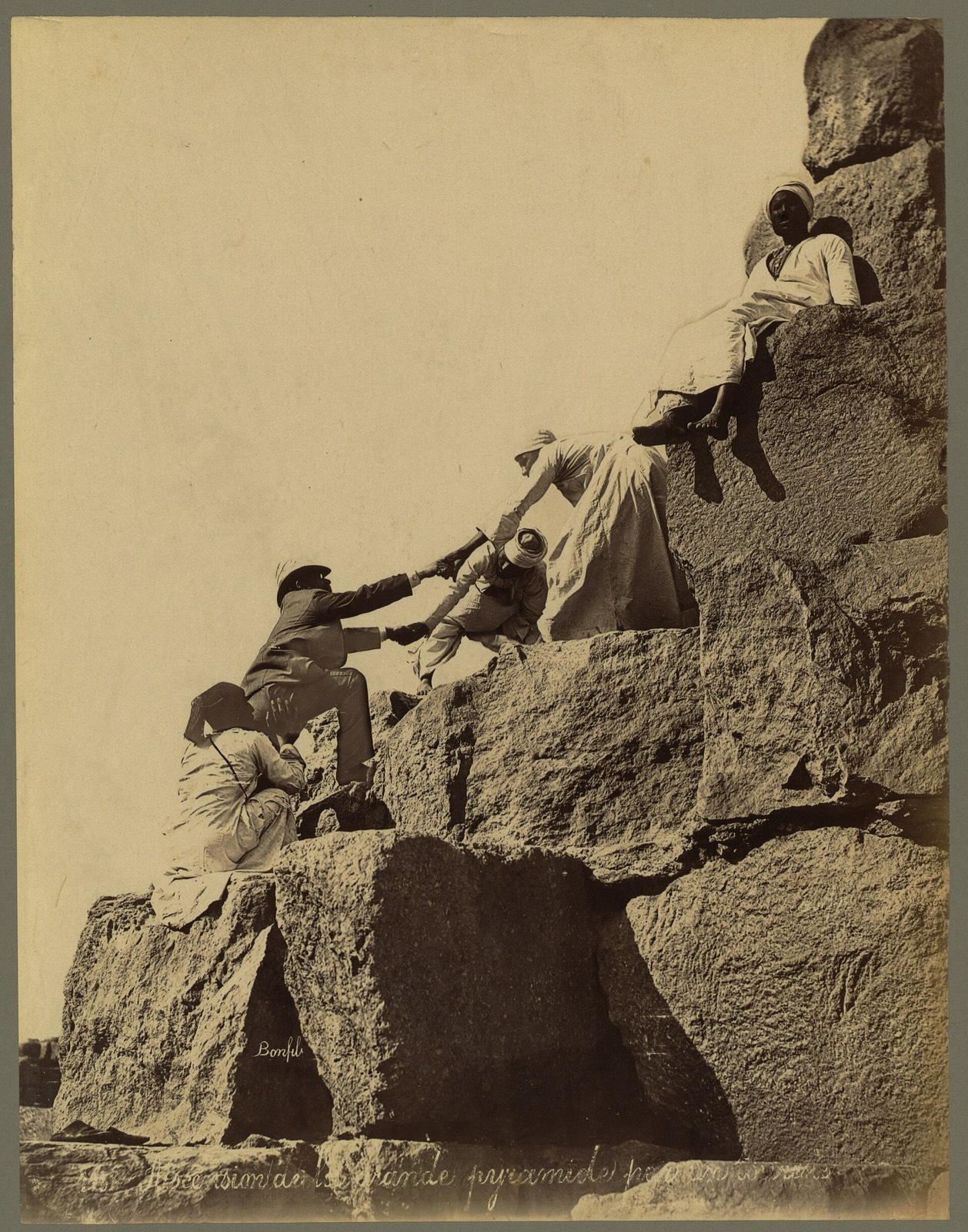 A visitor being hauled up the north-east corner of the Great Pyramid by local guides — a standard tourist experience of the 1870s, and a dangerous one.